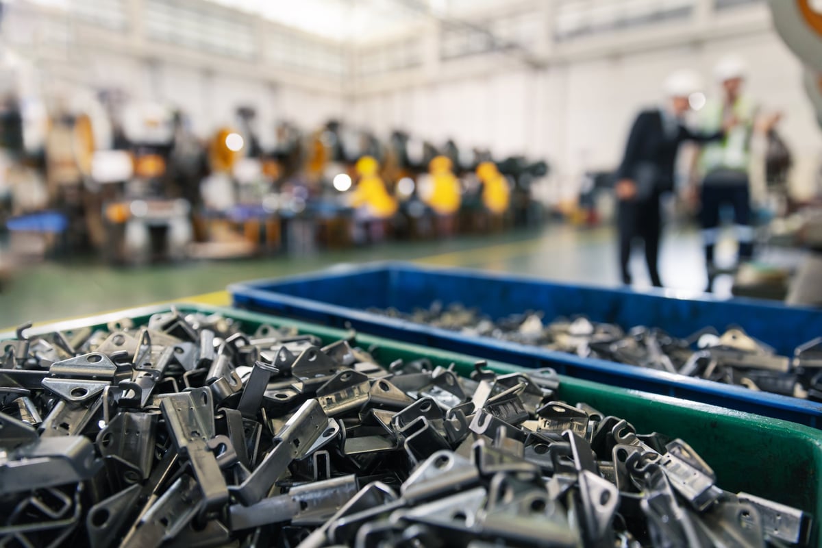 Precision stamped metal components organized in production bins